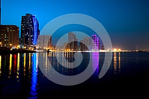 Sharjah downtown night scene with city lights, luxury new high tech town in middle East