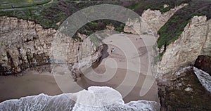 Shark Fin Cove Beach with a Towering rock and Sea Cave. California. Pacific  Ocean Waves. Island. Drone 10