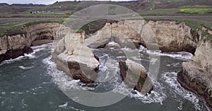Shark Fin Cove Beach with a Towering rock and Sea Cave. California. Pacific  Ocean Waves. Island. Drone 11