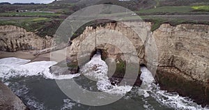 Shark Fin Cove Beach with a Towering rock and Sea Cave. California. Pacific  Ocean Waves. Island. Drone 12