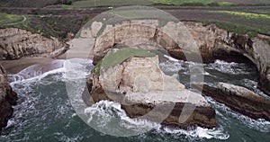 Shark Fin Cove Beach with a Towering rock and Sea Cave. California. Pacific  Ocean Waves. Island. Drone 15