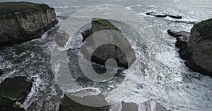 Shark Fin Cove Beach with a Towering rock and Sea Cave. California. Pacific  Ocean Waves. Island. Drone