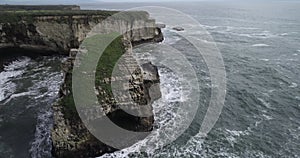 Shark Fin Cove Beach with a Towering rock and Sea Cave. California. Pacific  Ocean Waves. Island. Drone 4