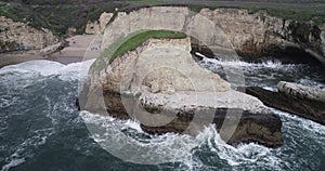 Shark Fin Cove Beach with a Towering rock and Sea Cave. California. Pacific  Ocean Waves. Island. Drone 6