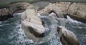 Shark Fin Cove Beach with a Towering rock and Sea Cave. California. Pacific  Ocean Waves. Island. Drone 7