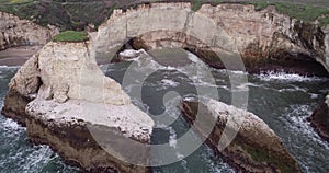 Shark Fin Cove Beach with a Towering rock and Sea Cave. California. Pacific  Ocean Waves. Island. Drone 8