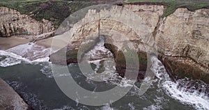 Shark Fin Cove Beach with a Towering rock and Sea Cave. California. Pacific  Ocean Waves. Island. Drone 9