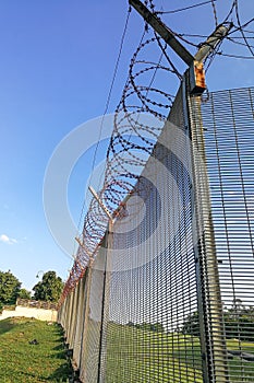 Sharp barbed wire on security fence protecti secure private space