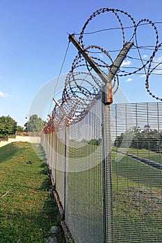 Sharp barbed wire on security fence protecti secure private space