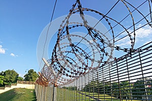 Sharp barbed wire on security fence protecti secure private space