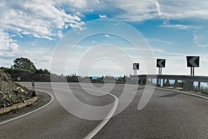 A sharp bend on an empty tarmac road