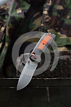 A sharp bright knife for a tourist and a hunter. Hunting knife with an orange handle