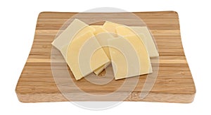 Sharp cheddar cheese on a small cutting board