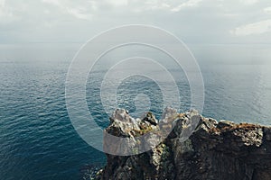Sharp cliffs hang over the ocean, Dramatic marine background