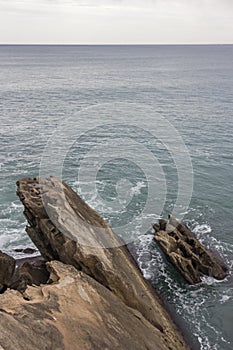 Sharp cobbles sticking out of the sea