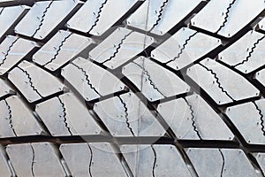 The sharp contrast and detail of the threads and grooves of a rubber tire.