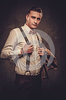 Sharp dressed man wearing suspenders and bow tie