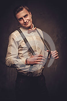 Sharp dressed man wearing suspenders and bow tie