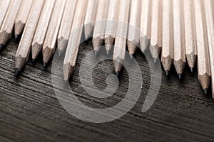 Sharp graphite pencils on a black background