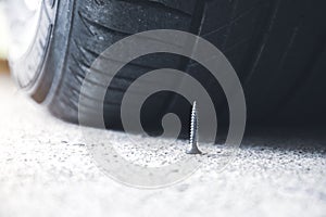 Sharp metal screw on road nearly to puncture a car tire