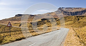 A Sharp Mountain Road Bend and Warning Sign