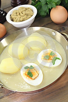 Sharp mustard eggs with sauce and potatoes