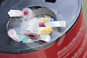 Sharp needles in biohazard container bin