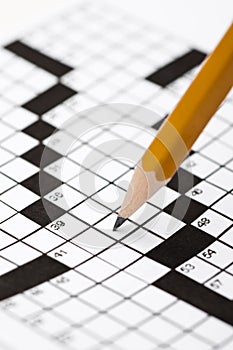 A sharp pencil on a crossword puzzle