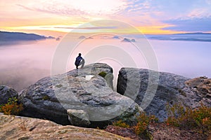 Sharp rear man silhouette on rocky peak. Satisfy hiker enjoy view. Tall man on rocky cliff