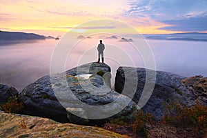 Sharp rear man silhouette on rocky peak. Satisfy hiker enjoy view. Tall man on rocky cliff