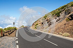 Sharp right bend of winding mountain road and white clouds ahead. Teide National Park, Tenerife, Canary Islands, Spain
