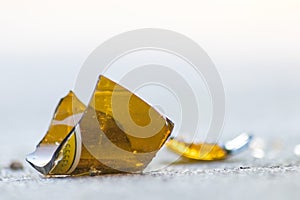 Sharp shards of a broken glass bottle on the ground with sharp blades are dangerous from vandalism and drunk people