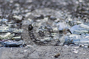 Sharp shards of a broken glass bottle on the ground with sharp blades are dangerous from vandalism and drunk people
