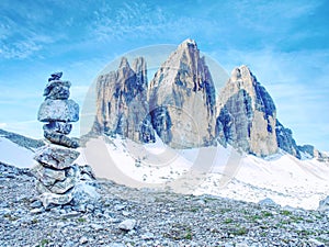 Sharp stones stacked into pyramid.  Mountain ridge in Italian Alps