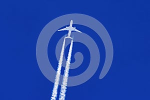 Sharp telephoto close-up of jet plane aircraft with contrails
