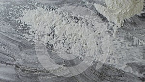 Sharp throw of fresh natural flour on a dark table. Slow motion, Full HD video, 240fps, 1080p. Process preparing of bake