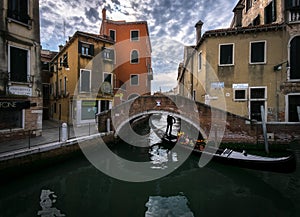The sharp turns of the Venetian canals. A day in the life of gondoliers. Reflections in sea water. Venice. Italy