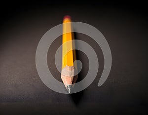 Sharp Yellow Pencil with Freshly Sharpened Tip on Smooth Surface