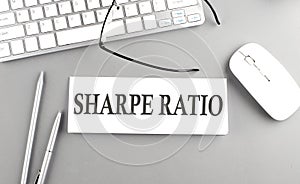 SHARPE RATIO text on paper with keyboard on grey background