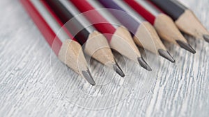 Sharpened classic graphite pencils with a multicolored wooden shell.