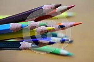 Sharpened color pencil on brown wood background