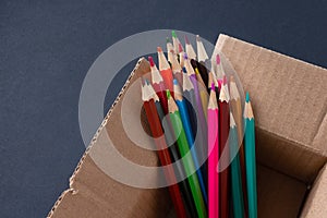 Colored pencils in a cardboard box