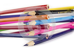 Sharpened colored pencils on the white background.
