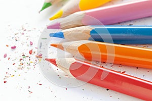 Sharpened colorful pencils and wood shavings, closeup