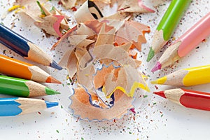 Sharpened colorful pencils and wood shavings, closeup