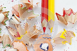 Sharpened colorful red and yellow pencils and wood shavings, drawing concept