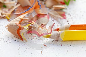 Sharpened colorful yellow and orange pencils and wood shavings, drawing concept