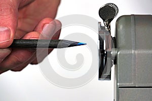 Sharpened pencil close to pencil sharpener