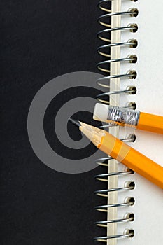 Sharpened pencil and a notebook