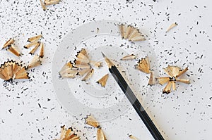 Sharpened pencil and shavings on white background